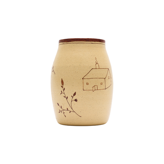 The Baile Homestead Vase by Baile is a handmade ceramic piece with a brown rim, beige surface, a simple house drawing, and hand-painted floral sprigs, shown against a plain white background.
