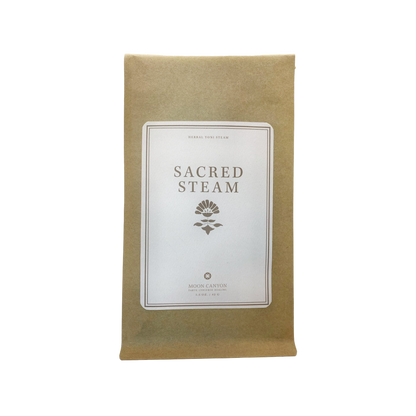 A brown paper pouch labeled "Sacred Steam Herbal Yoni Blend," has a white, rectangular label on the front featuring a small floral illustration and the text "Moon Canyon Healing" with "Los Angeles" at the bottom.
