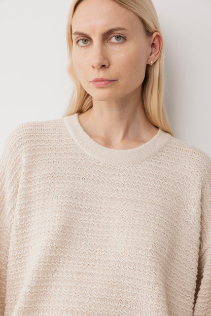 A woman with long blonde hair wears the Wol Hide Thermal Sweater in Natural, standing against a white background and facing the camera with a neutral expression.