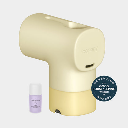Butter A beige Canopy Baby Bath Tub Filter with a yellow base is next to a small essential oil bottle. A "2023 Good Housekeeping Parenting Awards Winner" badge is shown. Fulfilled by Canopy. The background is light gray.