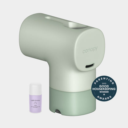 Jade A Canopy Baby Bath Tub Filter sits beside a small  essential oil bottle, Fulfilled by Canopy. A circular Good Housekeeping Parenting Awards 2023 winner badge is in the lower right corner.