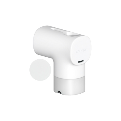 The Canopy Bath Tub Filter is a modern white cylindrical device with a rounded top and front branding. Designed for sensitive skin, it has a top opening and charging port below, making it ideal for effective chlorine removal.