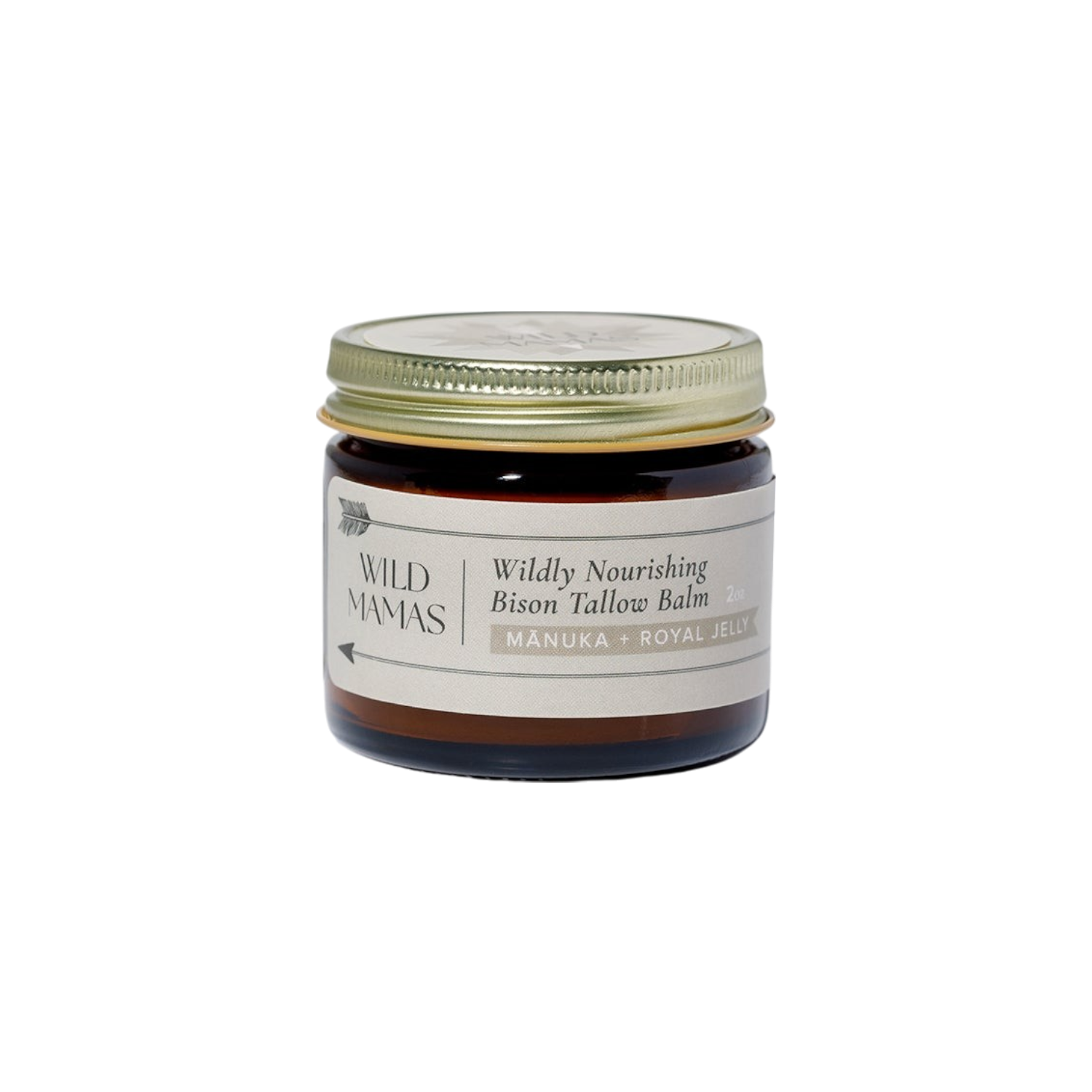 A small amber glass jar with a gold lid labeled "WildMamas Wildly Nourishing Bison Tallow Balm - Mānuka Honey + Royal Jelly." This nutrient-rich balm offers regenerative skincare in a minimalist, cream-colored design.