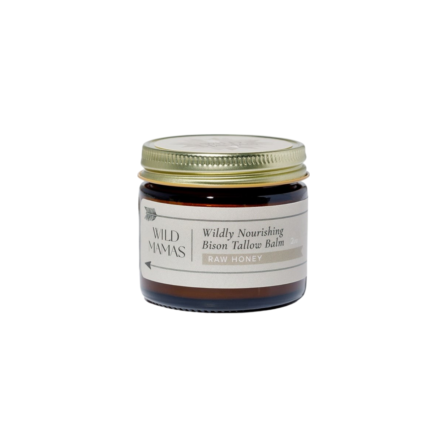 A small glass jar with a gold lid holds WildMamas Wildly Nourishing Bison Tallow Balm - Raw Honey, a luxurious natural skincare balm. The cream label displays elegant black and gold text.