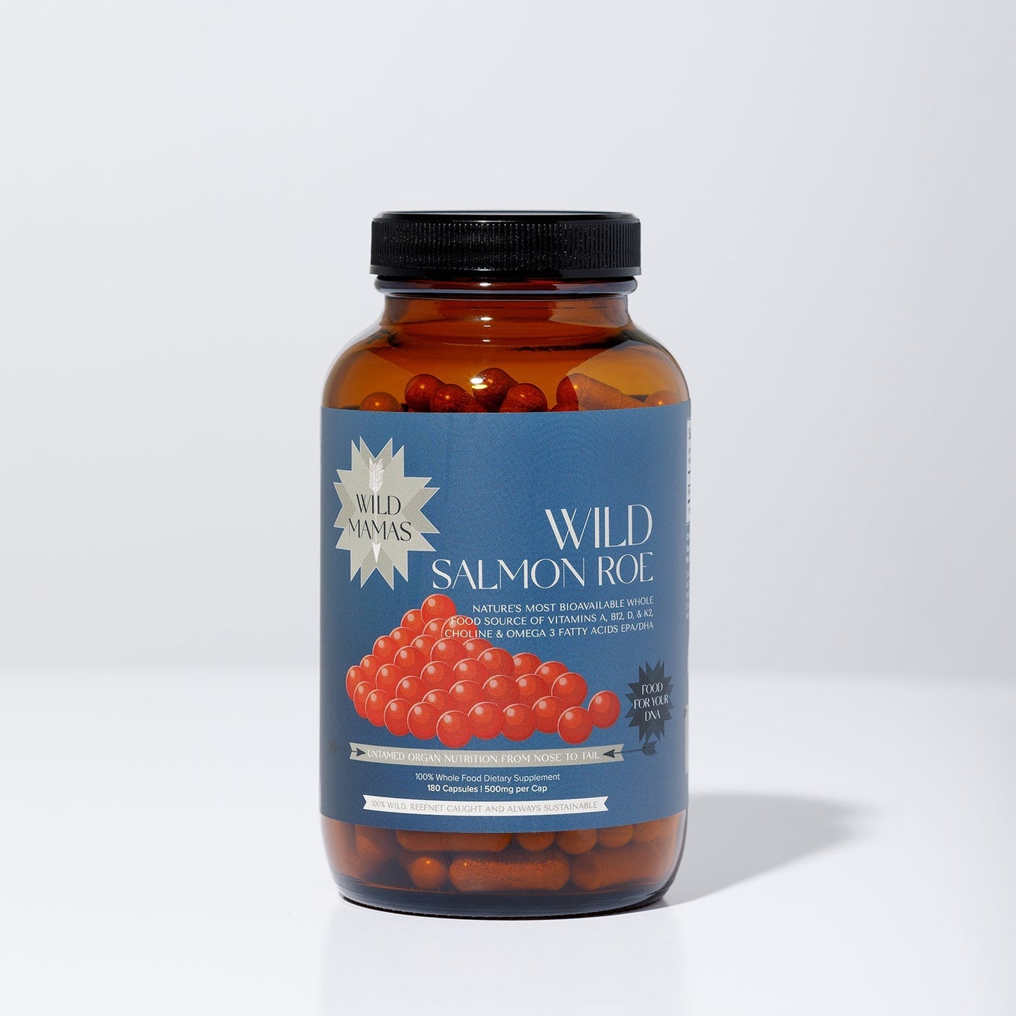 A brown glass jar with a black lid contains WildMamas Wild Salmon Roe, rich in Omega-3. The blue label shows orange roe, product info, and a gold "WildMamas" badge. The jar is set against a plain white background.