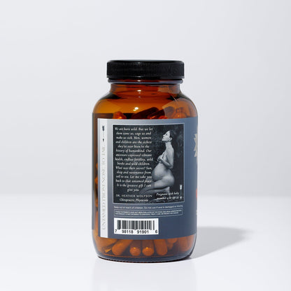 A brown WildMamas Wild Salmon Roe pill bottle with a black cap sits on a white background. The label shows a grayscale pregnant woman, barcode, and Omega-3 superfood benefits. Capsules are visible inside the bottle.