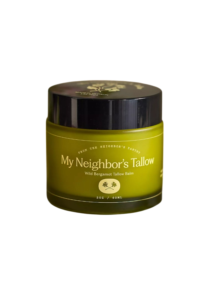 A green 2 oz jar of My Neighbor’s Tallow Wild Bergamot - Tallow Balm with a black lid and white text; this rejuvenating balm is rich in essential fatty acids.