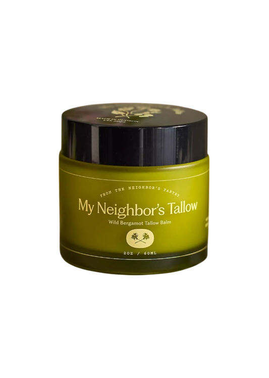 A green 2 oz jar of My Neighbor’s Tallow Wild Bergamot - Tallow Balm with a black lid and white text; this rejuvenating balm is rich in essential fatty acids.
