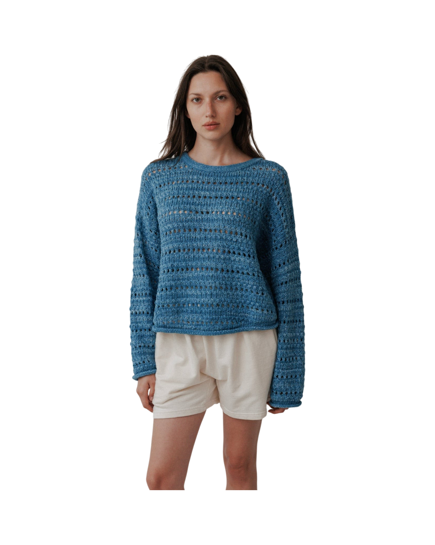 A person stands against a plain background wearing the Wol Hide Open Pullover in Indigo paired with beige shorts, looking directly at the camera.