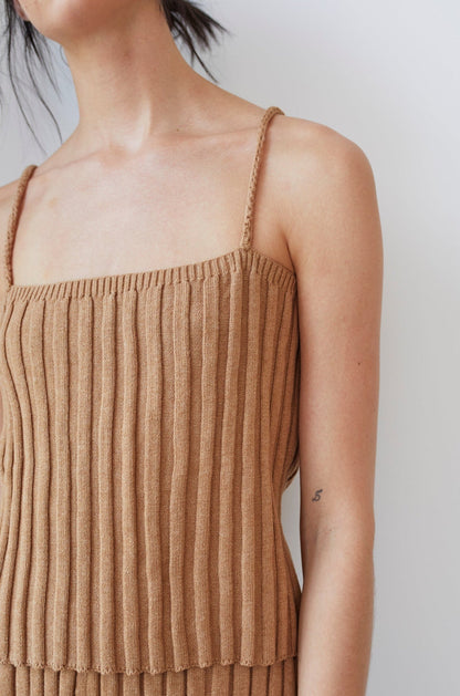 A person showcases the Wol Hide Organic Cotton Rib Cami in Toffee against a plain background, revealing only their shoulder and upper torso with a small tattoo visible on their arm.