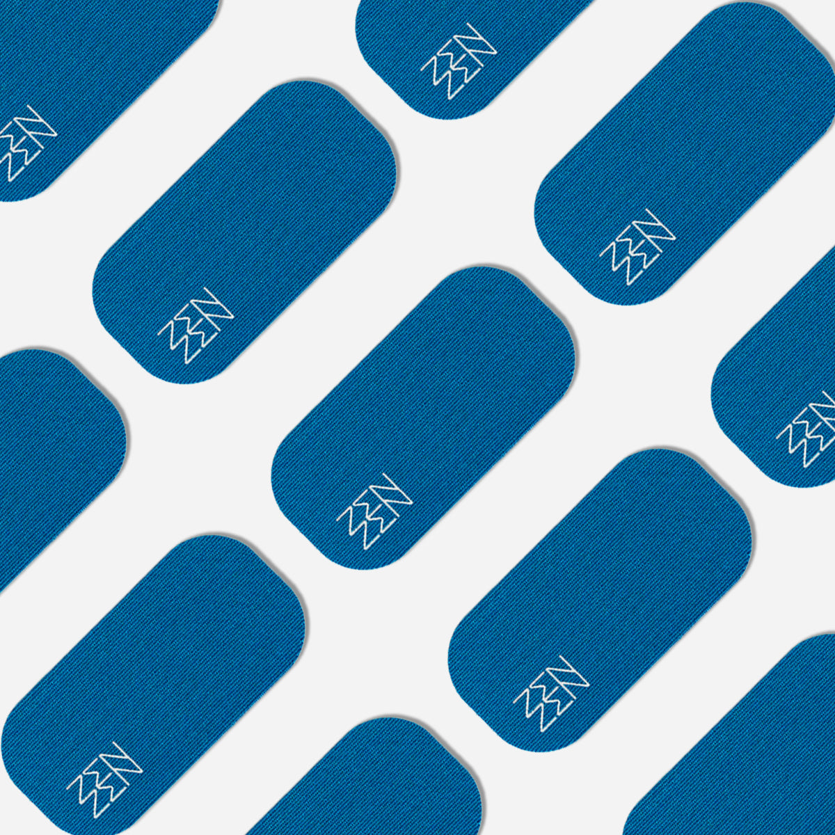 Blue rectangular patches with rounded corners are arranged diagonally on a white background. Each Zenzentape Pacific Breeze Mouthtape patch displays a simple white zigzag in one corner, crafted from organic bamboo silk for gentle sleep support.