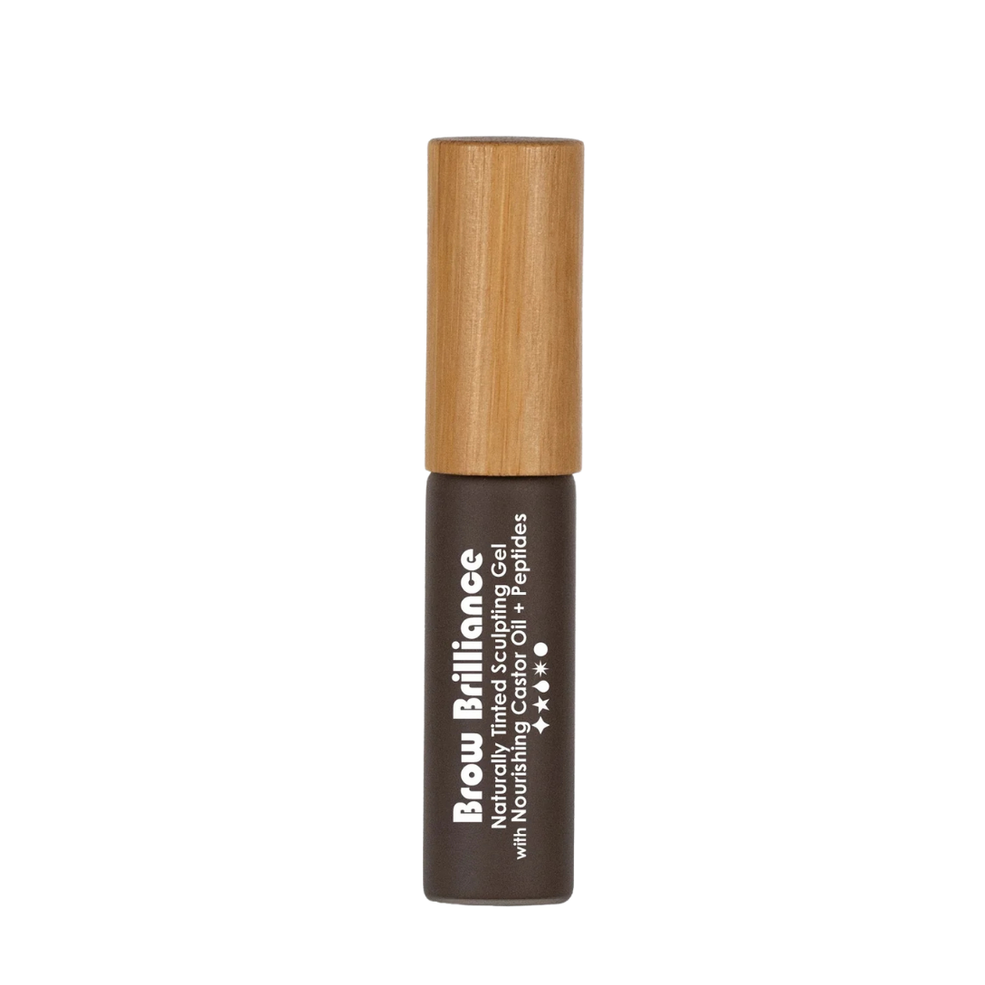 A small tube of Living Libations Brow Brilliance - Naturally Tinted Sculpting Gel features a wooden cap and a dark brown label with white text, promising natural brow fullness, set against a plain white background.