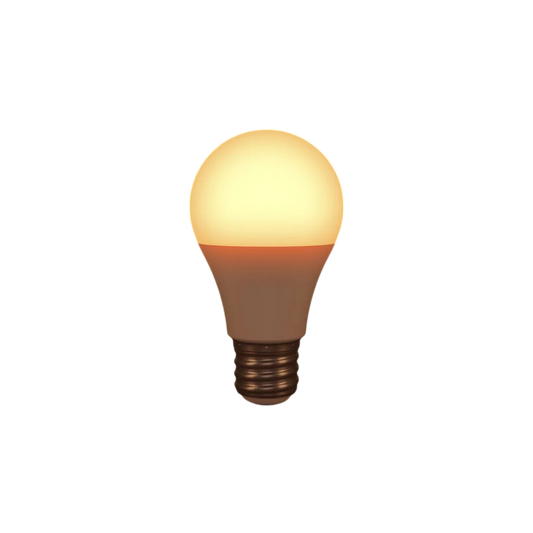 The Healthy Home Shop's Circadian Lightbulb, with a standard screw base and classic rounded shape, emits a circadian-friendly warm yellow light. The glowing filament stands out beautifully against a plain black background.