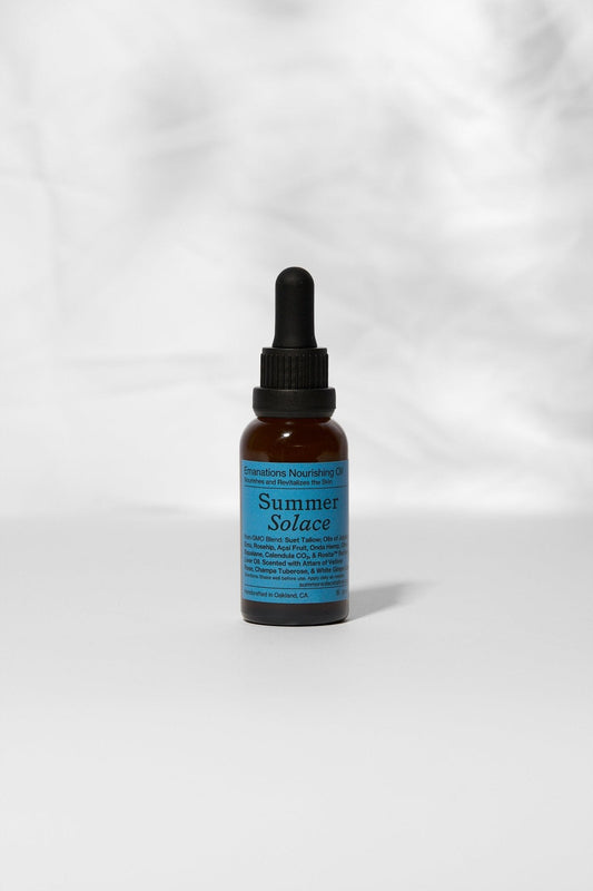 An amber dropper bottle labeled "Summer Solace Tallow" stands upright on a light surface. Its blue label reads "Emanations Profound Face Oil – Deeply Nourishing | Champa, Tuberose & White Ginger Lily," a nourishing face and hair oil.