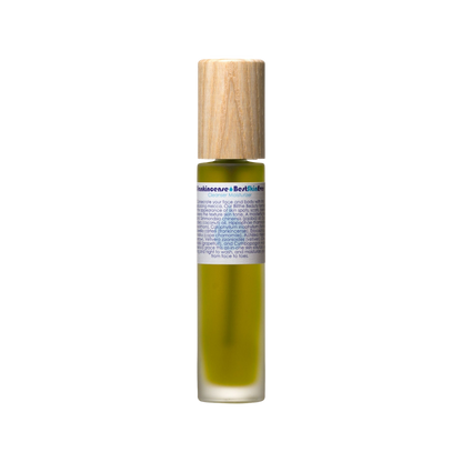 A small, cylindrical bottle containing a greenish-yellow cleanser, fitted with a wooden cap. The label features detailed information in multiple lines about "Best Skin Ever Cleanser- Frankincense" by Living Libations, suggesting its use as an acne redness soothing cleanser, exfoliator, and moisturizer.