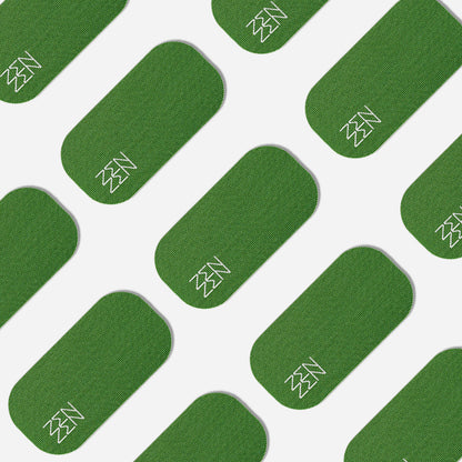 A pattern of green, rounded rectangles with white line drawings on a white background, inspired by the calming support of organic bamboo silk, reflects Zenzentape’s Evergreen Mouthtape.