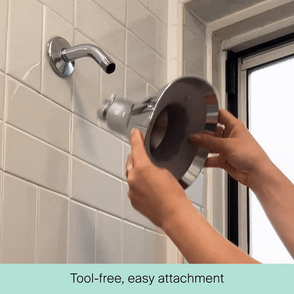 A person easily attaches Canopy’s Filtered Showerhead—a large, round model—to a wall-mounted shower arm without any tools. Text at the bottom reads, “Tool-free, easy attachment.” Fulfilled by Canopy.