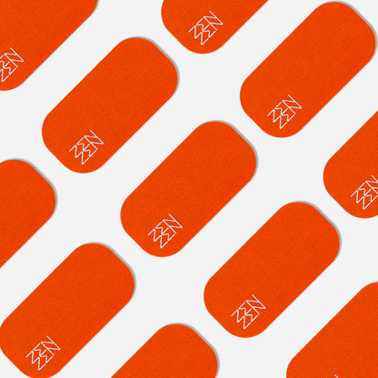 A repeating pattern of orange rectangles featuring a white minimalist lightning bolt in one corner, inspired by Zenzentape’s Socal Sunset Mouthtape, is arranged diagonally in alternating rows on a white background.