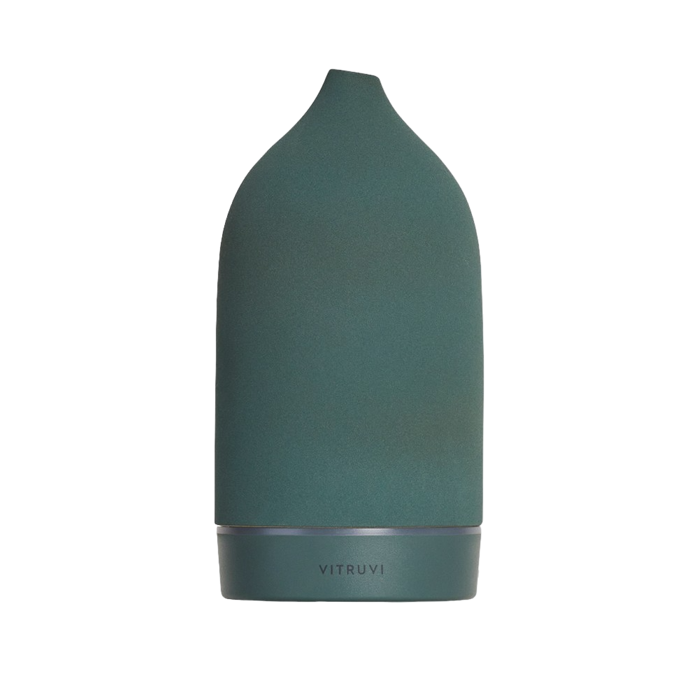 A dark green, conical-shaped Vitruvi Stone Diffuser with a soft matte finish and a tapered top. The word "VITRUVI" is inscribed at the base in subtle lettering. Designed to complement home decor, it uses pure essential oils for a minimalist and elegant touch.