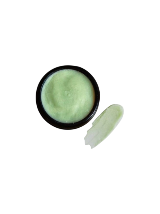 An open container of Wild Mamas Earth, Whipped & Sky 3.16oz tallow cream sits on a white background, with a dab beside it. Ideal for anyone seeking regenerative bison tallow skincare.