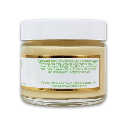 Simply Divine Botanicals' From Russia With Love Protective Regenerating Moisturizer is a vegan, Reiki-energized cream in a small glass jar with aloe vera, sea buckthorn, milk thistle, frankincense, and lavender for deep hydration.