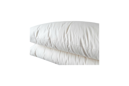 The Ashland Organic Wool Pillows from Shepherd's Dream are stacked on top of each other against a transparent background. These natural sleep pillows, with their fluffy white appearance, look soft and inviting while featuring neatly aligned seams and a smooth texture.