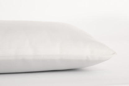A close-up view of the Shepherd's Dream Child's Sleep Pillow on a white background, highlighting its smooth fabric and simple design ideal for little ones.