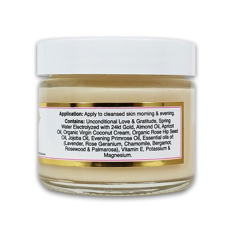 Rose du Jour Light Soothing Moisturizer by Simply Divine Botanicals is a luxurious face cream in a glass jar with a white lid. Infused with 24kt gold, almond oil, jojoba oil, and essential oils to support collagen production. Directions and ingredients on label.