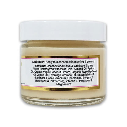 Rose du Jour Light Soothing Moisturizer by Simply Divine Botanicals is a luxurious face cream in a glass jar with a white lid. Infused with 24kt gold, almond oil, jojoba oil, and essential oils to support collagen production. Directions and ingredients on label.