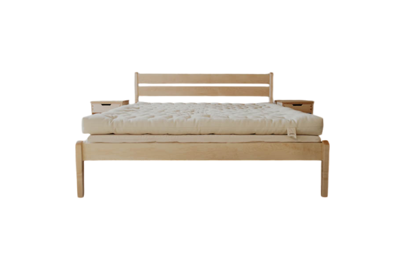 A minimalist wooden Cascade Latex Mattress Base from Shepherd's Dream, featuring a sleek headboard and a substantial light-colored natural latex foam mattress. It has a natural finish with clean lines and modern design, paired with an organic cotton encasement. The setup does not include visible bedding or pillows.