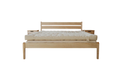 A minimalist wooden Cascade Latex Mattress Base from Shepherd's Dream, featuring a sleek headboard and a substantial light-colored natural latex foam mattress. It has a natural finish with clean lines and modern design, paired with an organic cotton encasement. The setup does not include visible bedding or pillows.