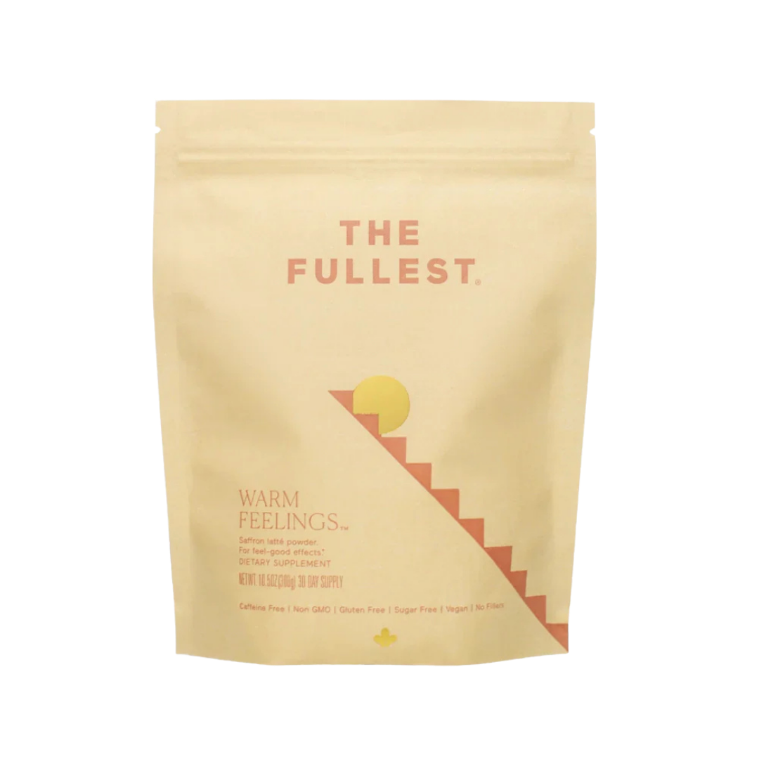 THE FULLEST’s Warm Feelings 30-Day Supply comes in a beige resealable pouch. The minimalist sun and staircase design reflect its mood-supporting, caffeine-free saffron formula—perfect for a calming daily latte ritual.