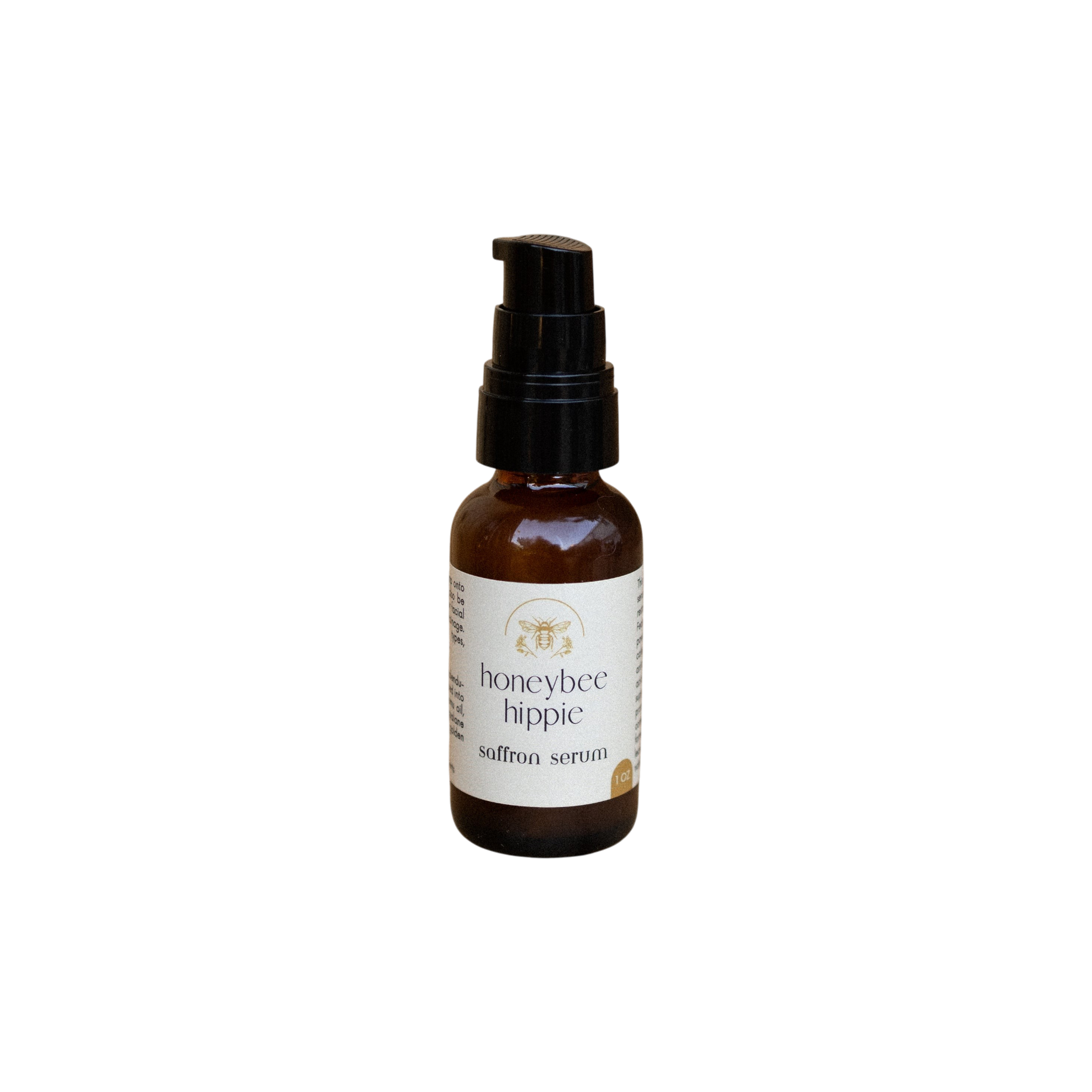 A small brown bottle with a black pump, labeled "Honeybee Hippie Saffron Serum," a hydrating botanical elixir for skin brightening, stands upright on a plain white background.