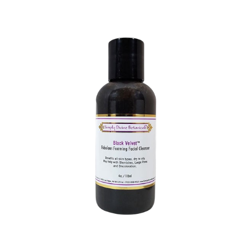A black bottle with a black cap labeled "Black Velvet Gentle Purifying Facial Cleanser" by Simply Divine Botanicals, an all-natural cleanser and gentle makeup remover, set against a plain white background.